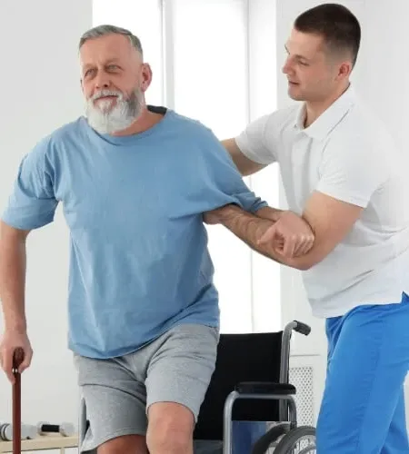 Physical therapist assisting a patient with mobility