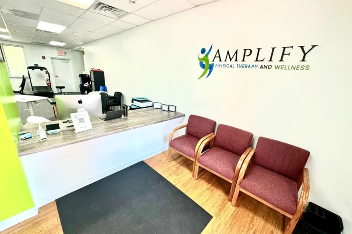 The open treatment floor where one-on-one sessions happen at Amplify Physical Therapy and Wellness