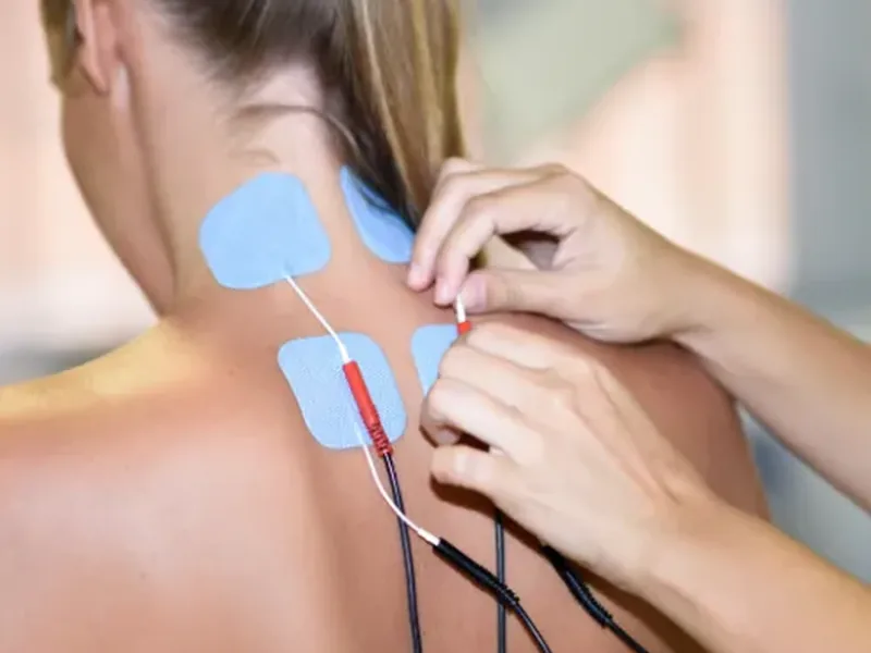 Marc Pro electrical stimulation pads placed on a patient during a one-on-one session at Amplify Physical Therapy and Wellness in Bolingbrook