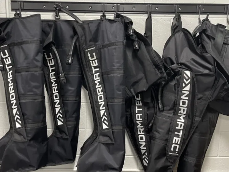 Normatec Pro compression sleeves wrapped around a patient&rsquo;s legs during a one-on-one visit at Amplify Physical Therapy and Wellness in Bolingbrook